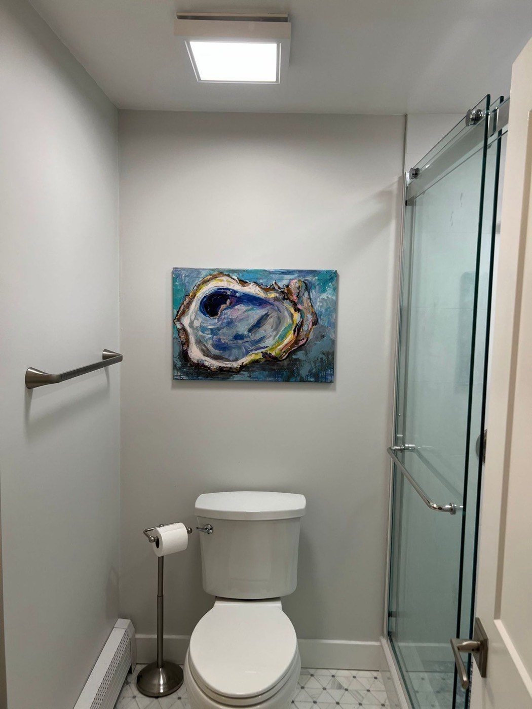 Bathroom remodel finished with framed artwork
